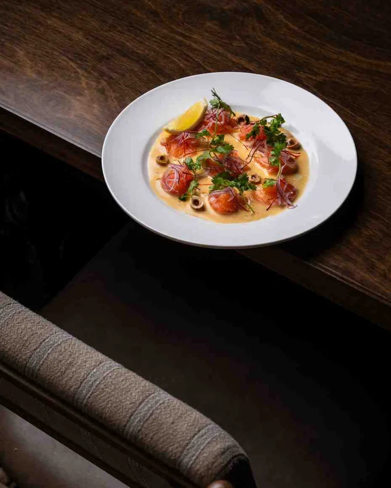 Plated tiradito on dark wood