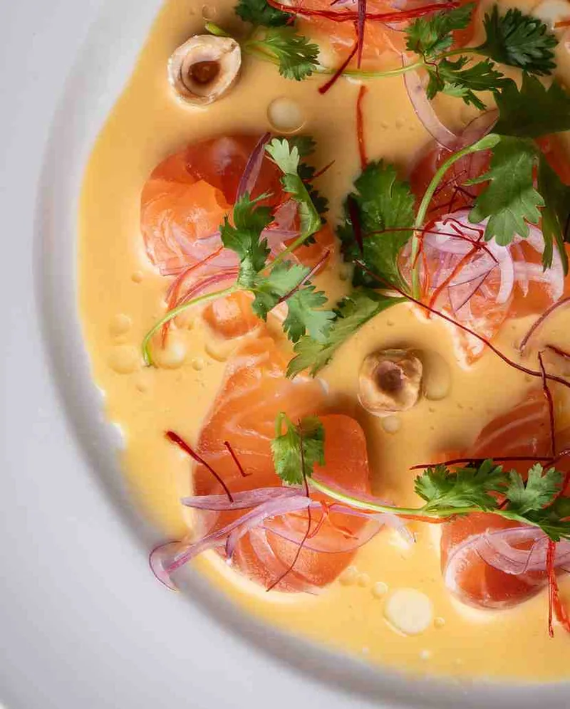 Salmon tiradito close-up with aji amarillo